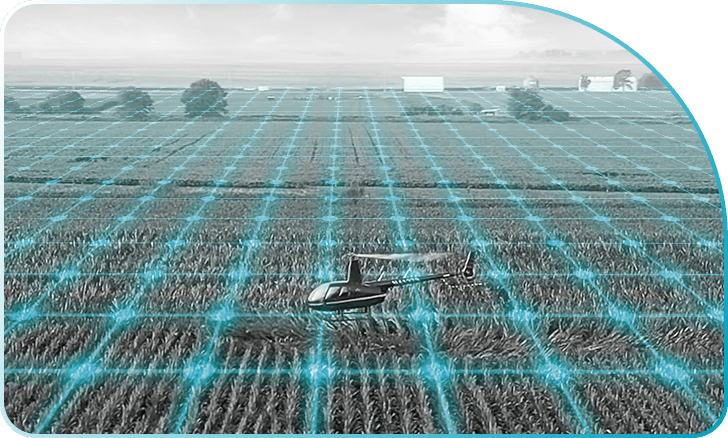 helicopter flying over a field testing product trials